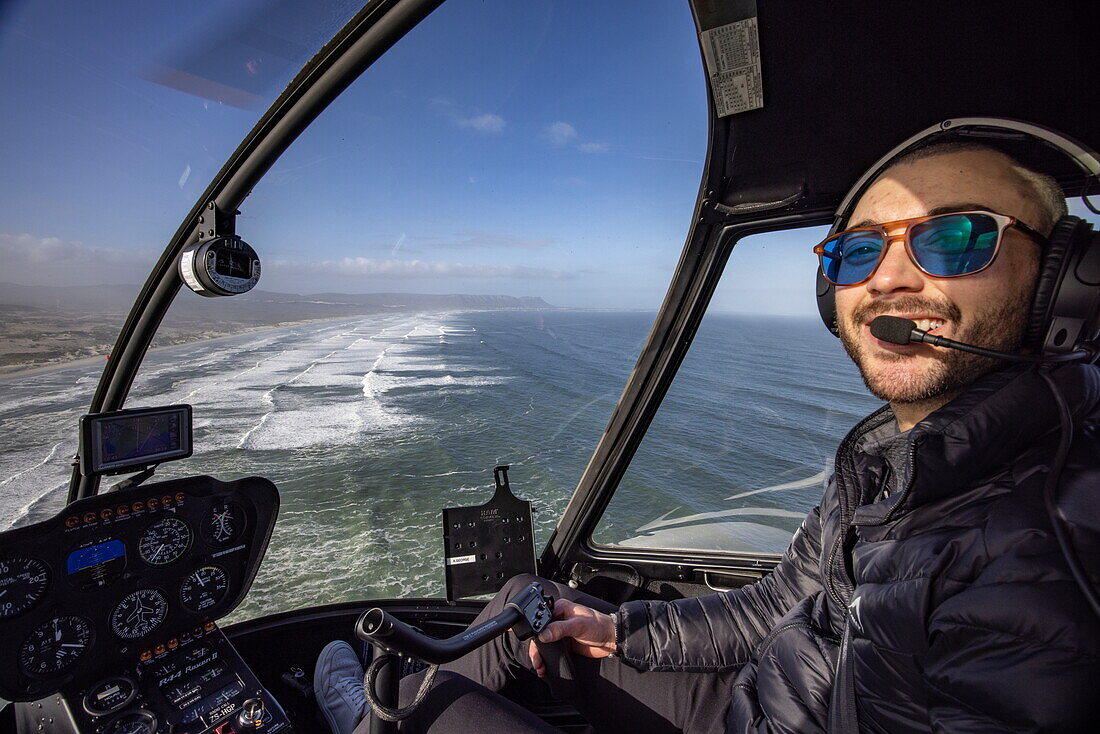 Aerial view of a helicopter pilot working over the coast and beach at Walker Bay Nature Reserve, Gansbaai De Kelders, Western Cape, South Africa