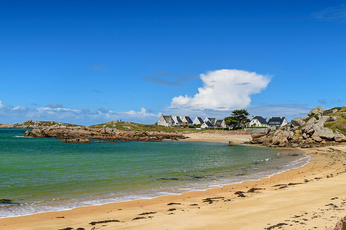 Sandy beach with houses in the background, Trégastel, Côte de Granit Rose, Brittany, France