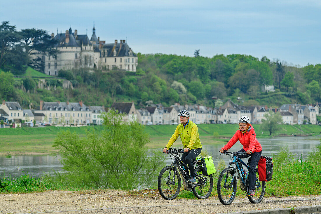 Man and woman cycling with Château de Chaumont in the background, Loire cycle path, Loire castles, Loire Valley, UNESCO World Heritage Loire Valley, France