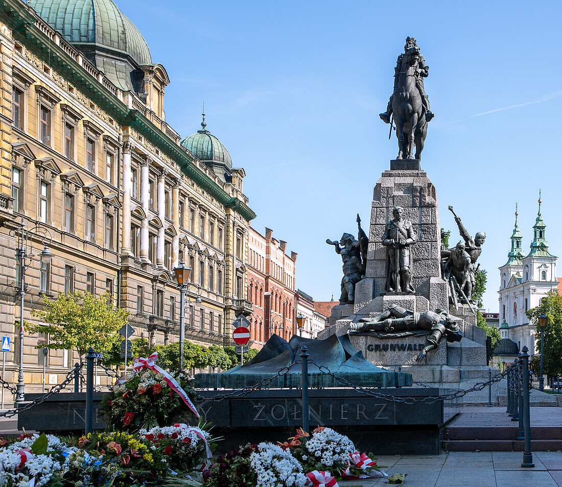 Matejko Square (plac Jana Matejki) with Tomb of the Unknown Soldier (Grób Nieznanego Żołnierza) and Grundwald Monument (Pomnik Bitwy pod Grunwaldem) with a view of St. Florian's Basilica (Bazylika św. Floriana) in Kraków in Poland