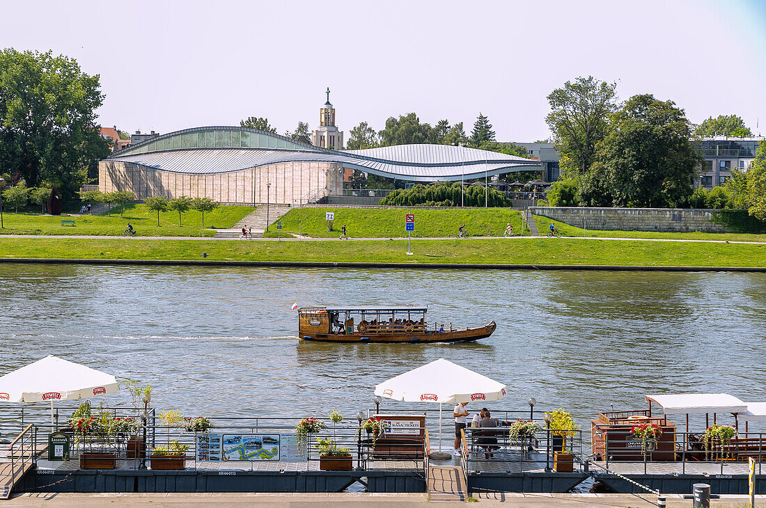 Vistula (Wisła) and Vistula Boulevard (Bulwary Wiślane) with boat pier, Krakow water tram and Manggha - Museum of Japanese Art and Technology (Muzeum Sztuki i Techniki Japońskiej Manggha) in the Old Town of Kraków in Poland