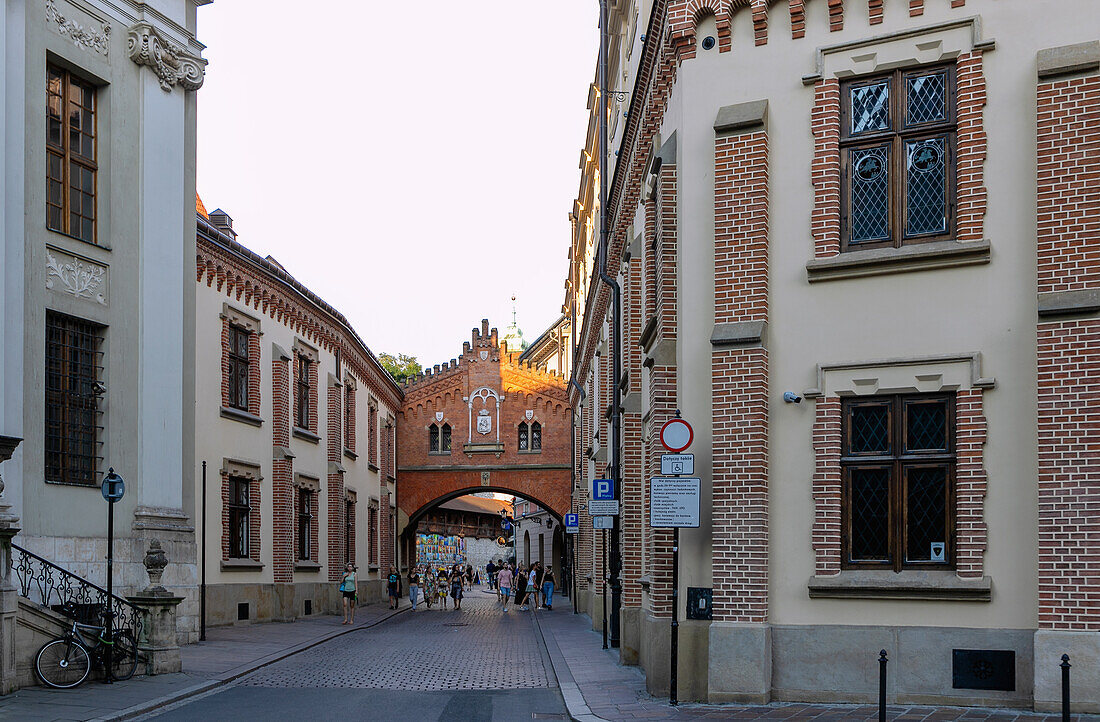 Pijarska Street with a view of the city walls at St. Florian's Gate (Brama Floriańska) and Czartoryski Museum (Klasztorek Muzeum Książąt Czartoryskich) in the Old Town of Kraków in Poland