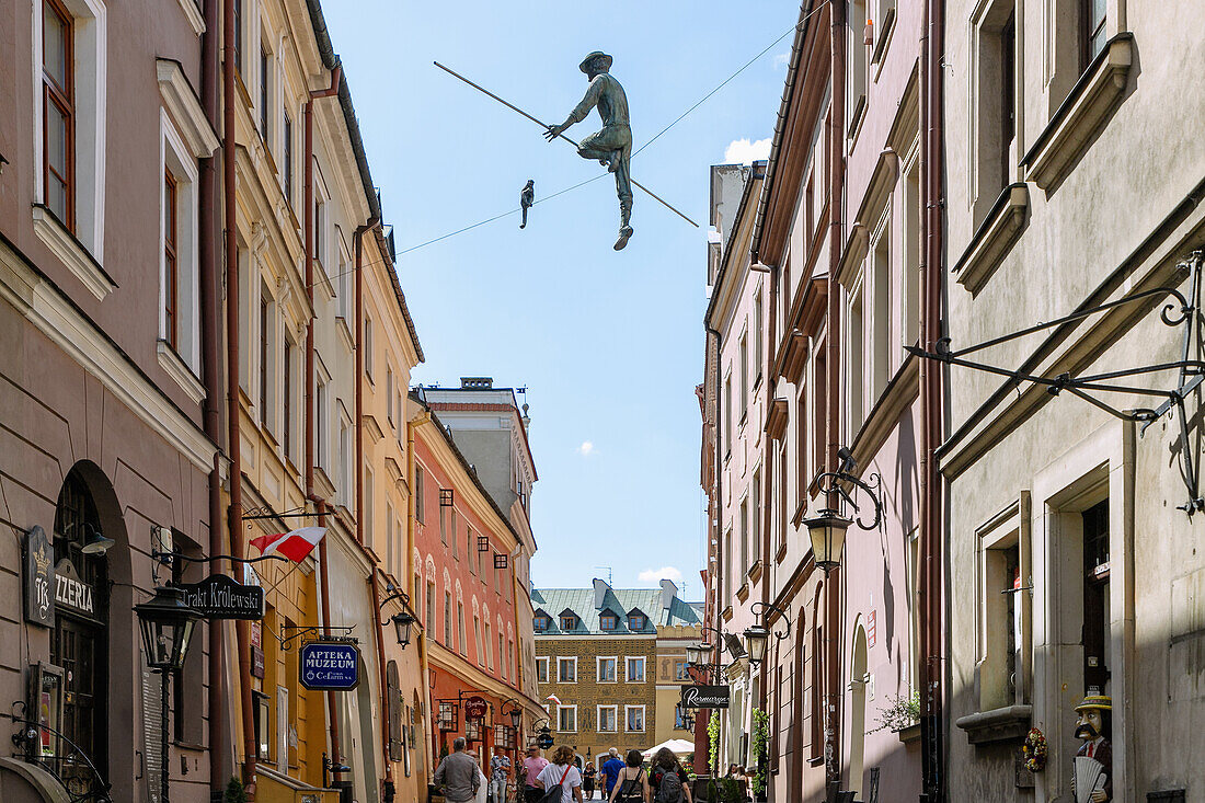 Burggasse (Grodzka), Pharmacy Museum (Apteka Muzeum) and sculpture of tightrope walker Jasza Mazur from the novel &quot;A Wizard from Lublin&quot; by Isaac Bashevis Singer in Lublin in Lubelskie Voivodeship of Poland