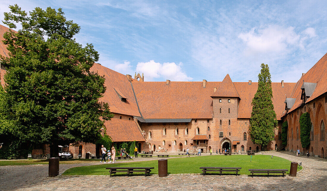 Inner courtyard of the central castle of the Marienburg (Zamek w Malborku) with a monumental figure of the Virgin Mary in Malbork in the Pomorskie Voivodeship in Poland