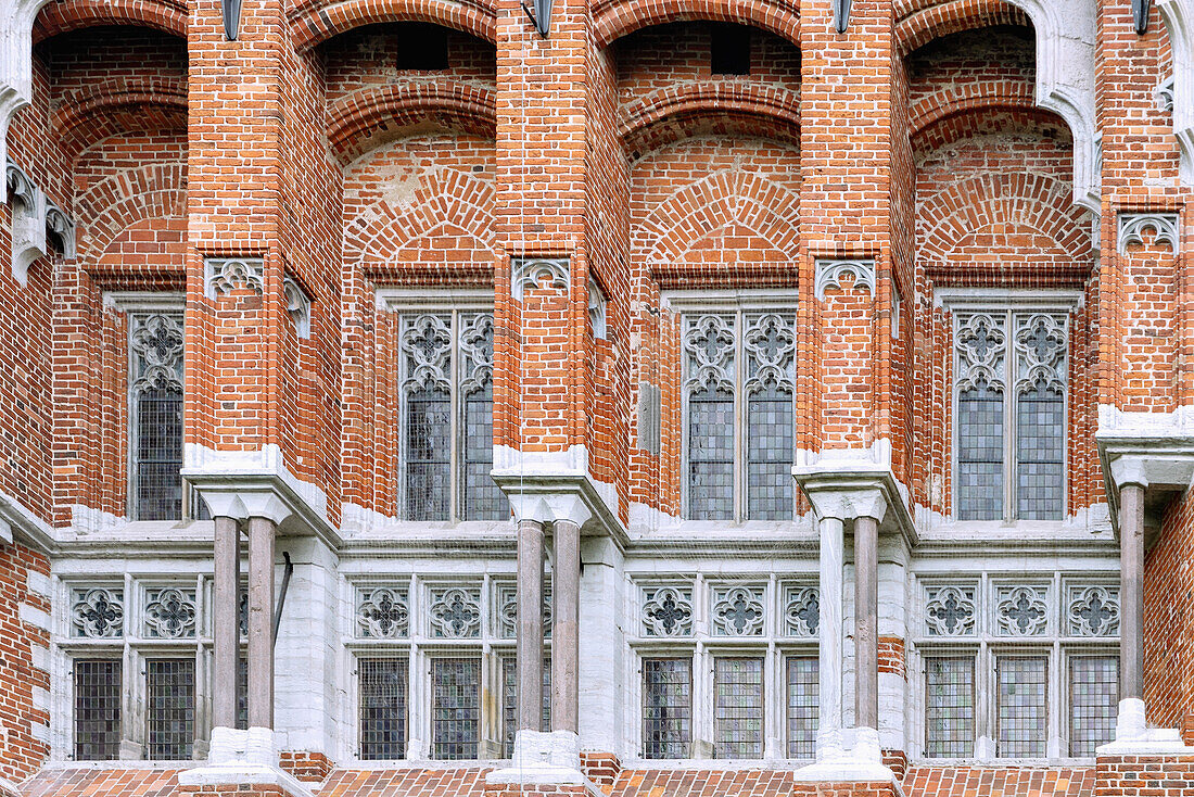 Brick facade of the Grand Master's Palace of the Marienburg (Zamek w Malborku) with a monumental figure of the Virgin Mary in Malbork in the Pomorskie Voivodeship of Poland