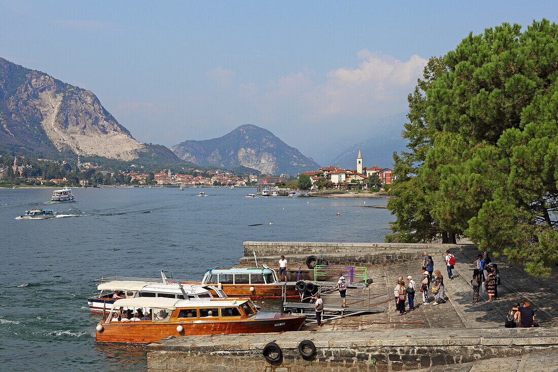 View of Isola Superiore (Isola dei Pescatori), in the foreground boats on the quay from Isola Bella, Lake Maggiore, Piedmont, Italy