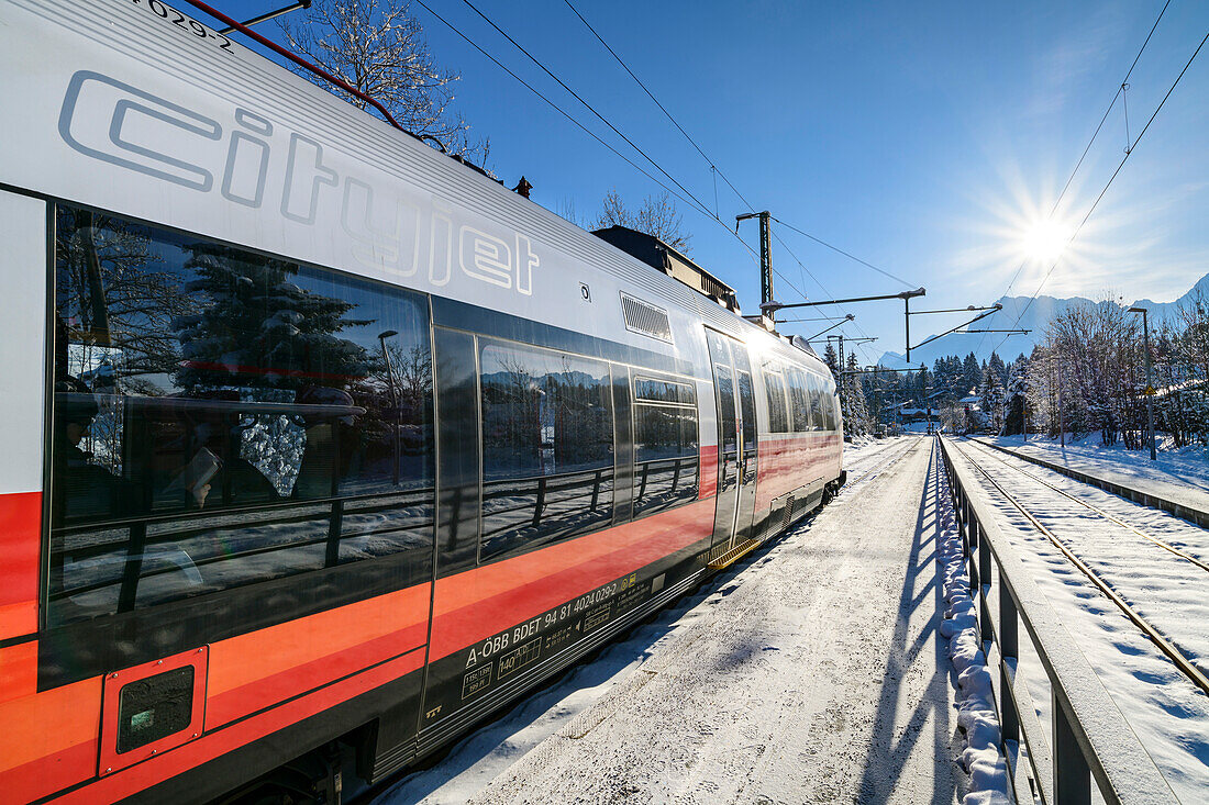 Train at the snowy Klais train station, Werdenfels, Upper Bavaria, Bavaria, Germany