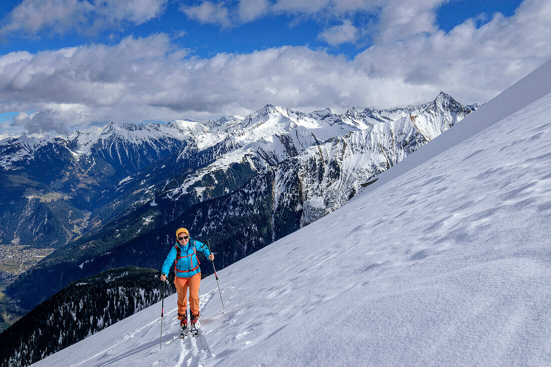 Woman on ski tour ascending to Grinbergspitze, Ahornspitze and Dristner in background, Grinbergspitze, Tuxer Kamm, Zillertal Alps, Tyrol, Austria