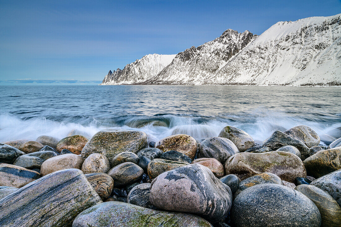 Surf washes over colorful boulders in Ersfjord, Ersfjord, Senja, Troms og Finnmark, Norway