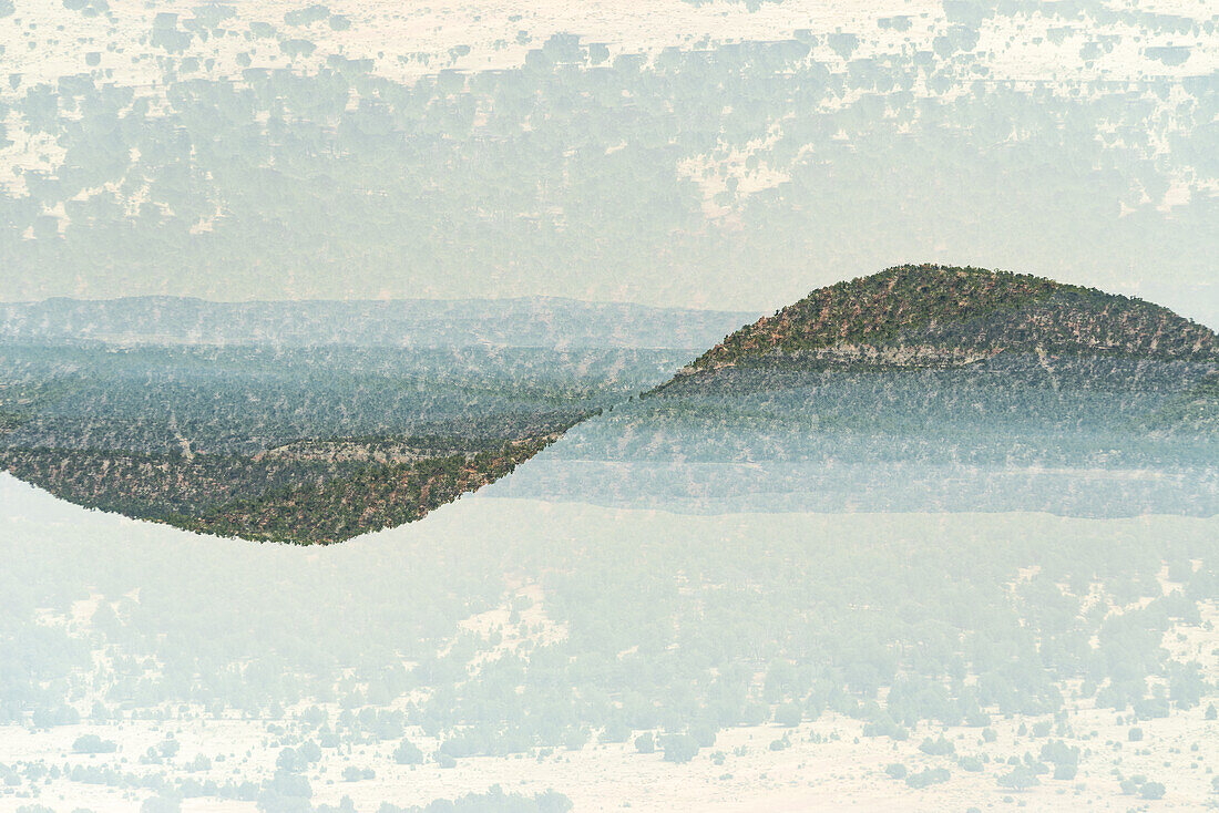 Double exposure of hills in New Mexico forming a waveform.