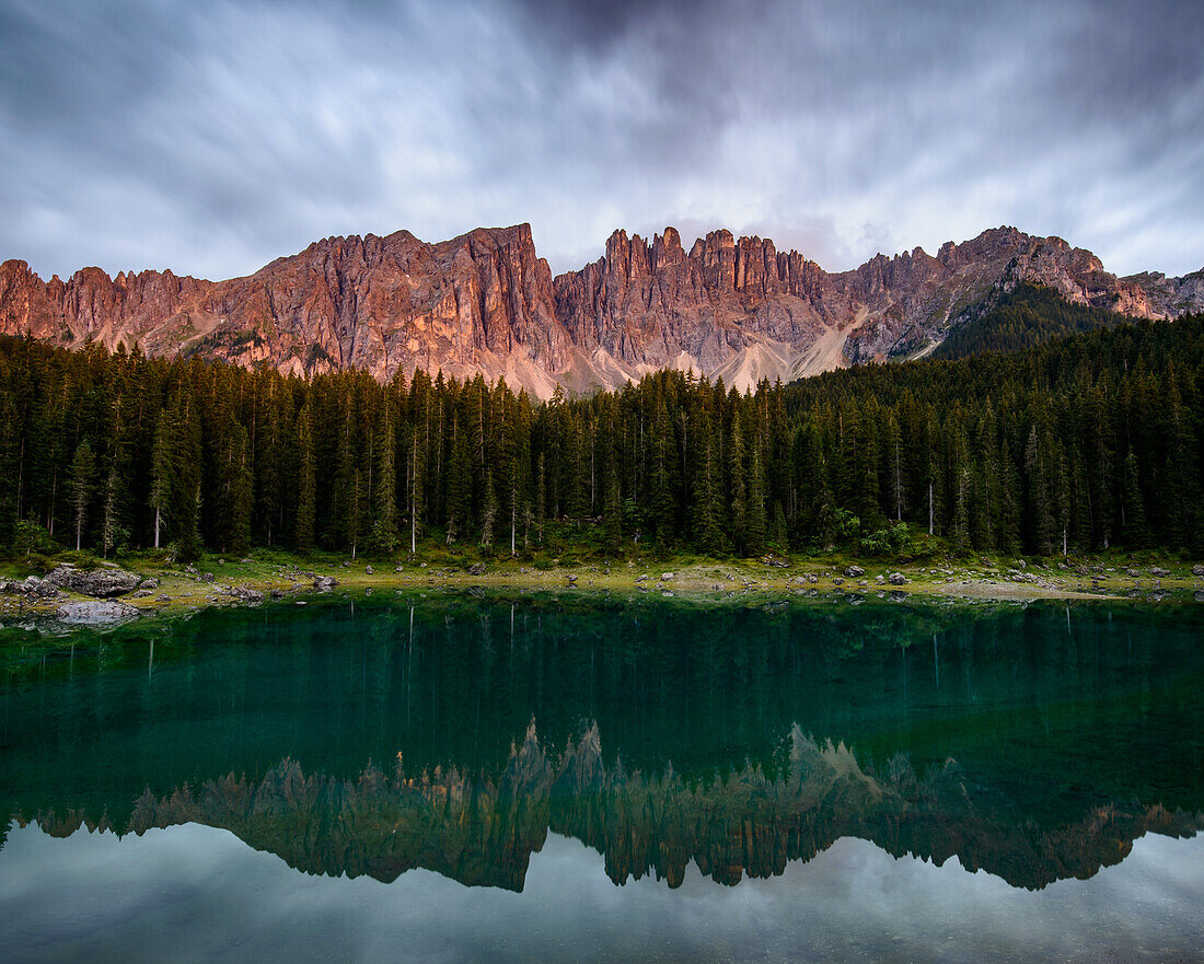 Light alpenglow at Lake Karrersee, Dolomites, South Tyrol, Italy