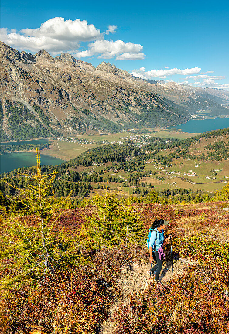 Hiker in the Engadin Valley with a view of Sils im Engadin, Graubünden, Switzerland