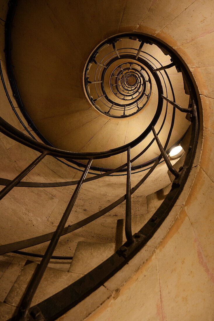 Spiral staircase in the Arc de Triomphe de l'Étoile to the modern high-rise district of La Défense, Paris, Île-de-France, France, Europe