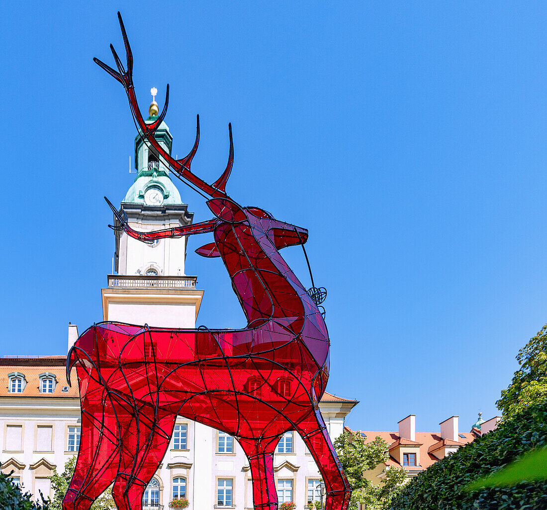 Rathausplatz (Rynek, Plac Ratuszowy) mit roter Hirsch-Skulptur und Rathaus (Ratusz) in Jelenia Góra (Hirschberg) im Riesengebirge (Karkonosze) in der Woiwodschaft Dolnośląskie in Polen