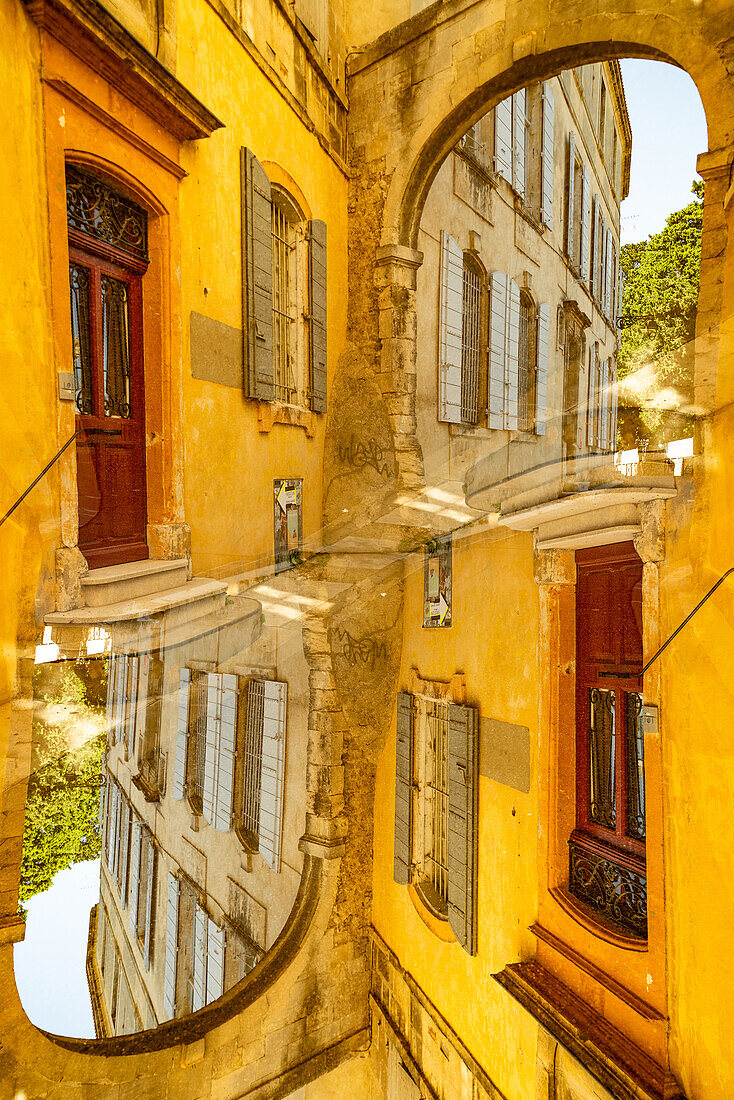 Graphic double exposure of a arched gate in the medieval town of Arles, France.