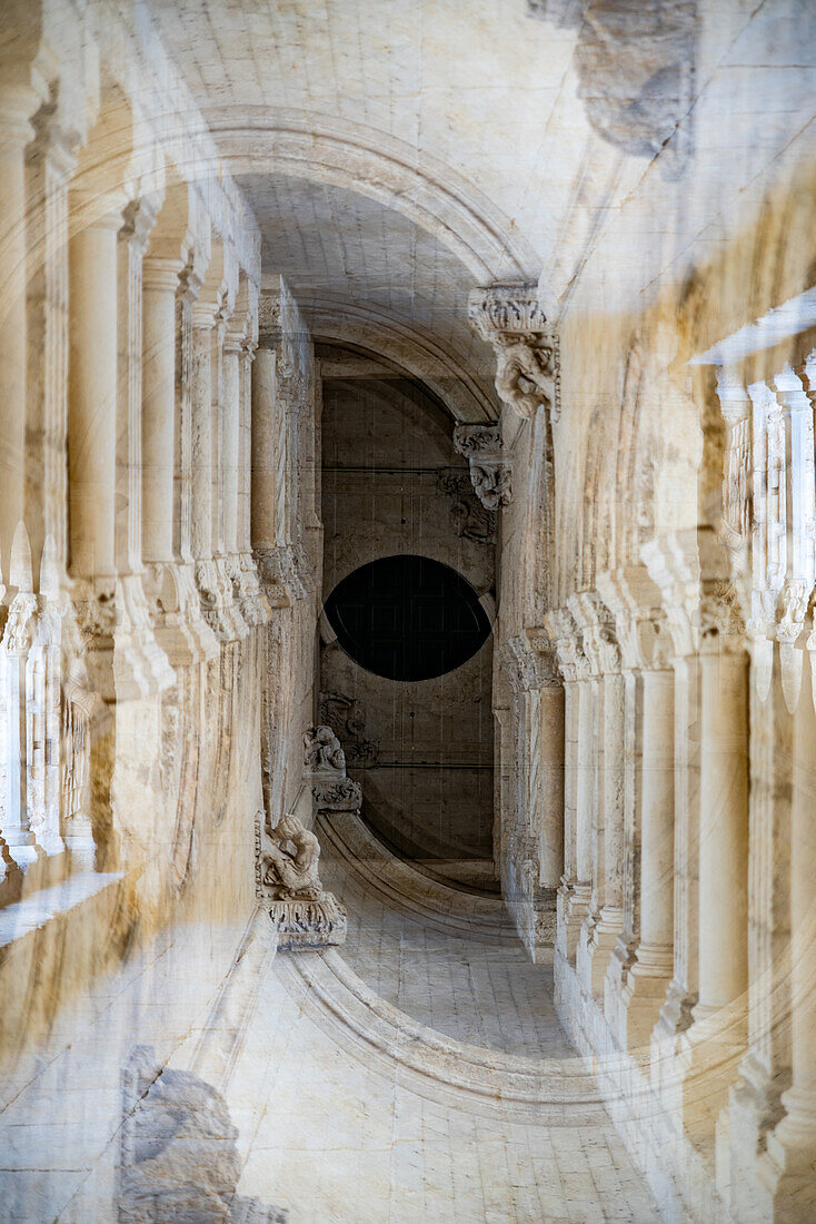 Double exposure of stone arches in the medieval town of Arles, France.