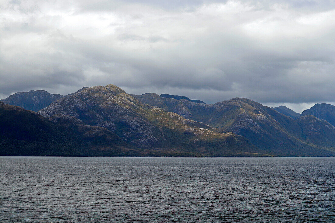 Chile; Southern Chile; Aysen region; Mountains of the southern Cordillera Patagonica; on the Navimag ferry through the Patagonian fjords; Canal Messier; Rain clouds over the mountain landscape