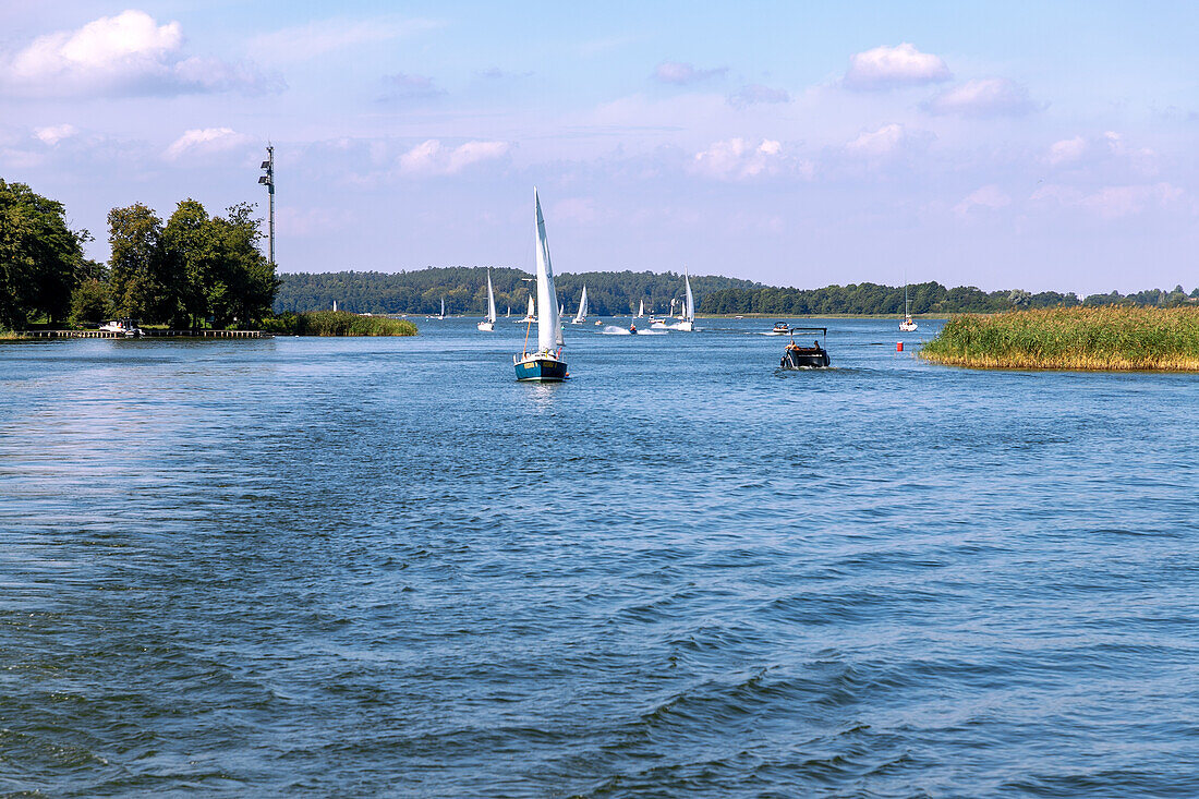 Sailing boats on the Jezioro Mikołajskie (Lake St. Nicholas) at the transition to Jezioro Śniardwy (Spirding Lake) in Masuria (Mazury) in the Warmińsko-Mazurskie Voivodeship in Poland