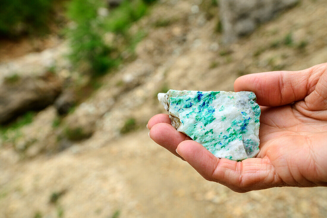 Frau hält Stein mit Malachit und Azurit in der Hand, Kupferbergbau, Gratlspitze, Wildschönau, Kitzbüheler Alpen, Tirol, Österreich 