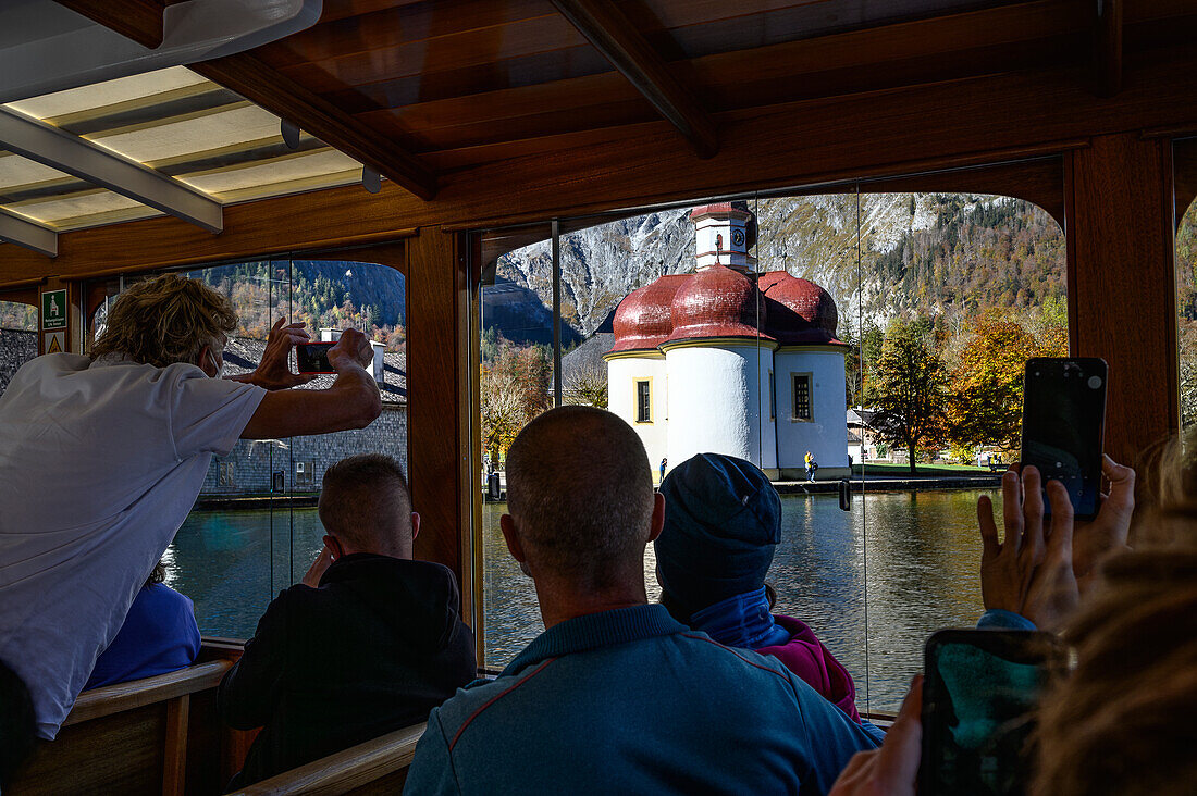 View from wooden boat, tourist boat trip/shipping on the Königssee, Königssee with St. Bartholomä Church in front of Watzmann east wall, Königssee, Berchtesgaden National Park, Berchtesgaden Alps, Upper Bavaria, Bavaria, Germany