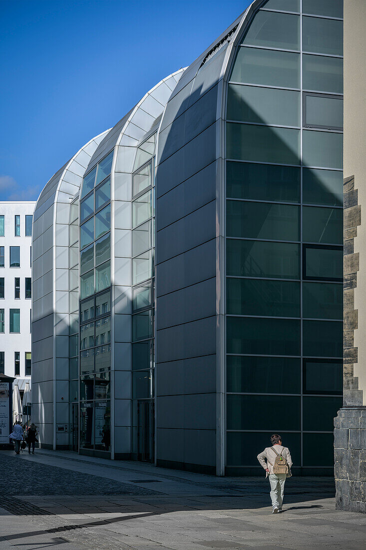 Woman walking along modern facade of a department store, Chemnitz, Saxony, Germany, Europe