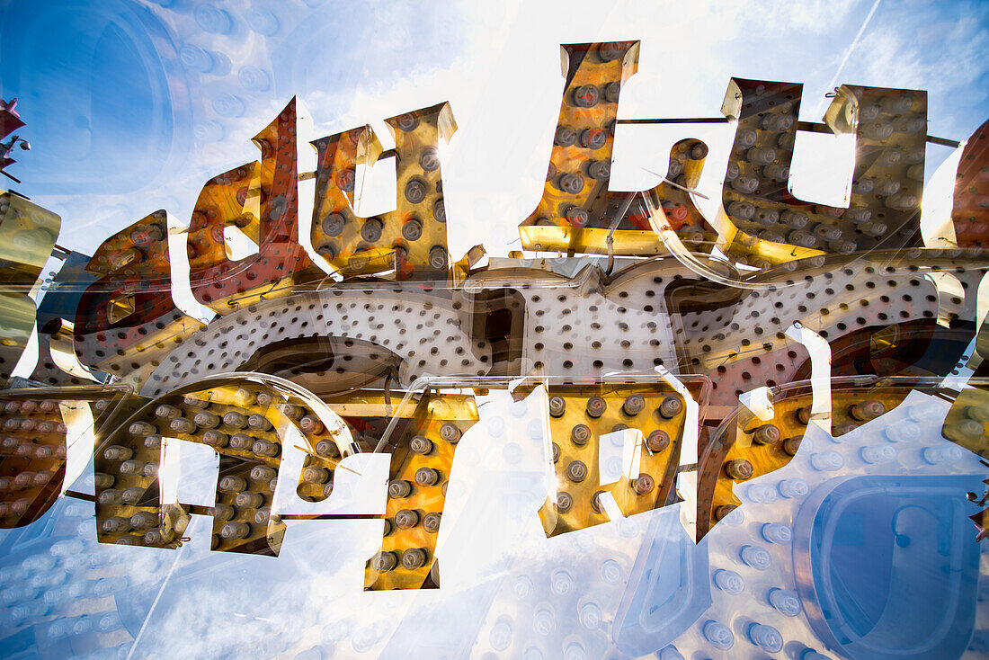 Double exposure of abandoned and discarded neon Lucky sign in the Neon Museum aka Neon boneyard in Las Vegas, Nevada.