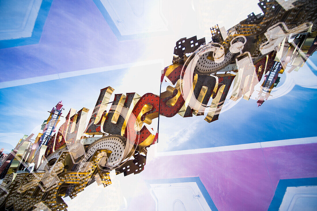 Double exposure of abandoned and discarded neon Lucky sign in the Neon Museum aka Neon boneyard in Las Vegas, Nevada.