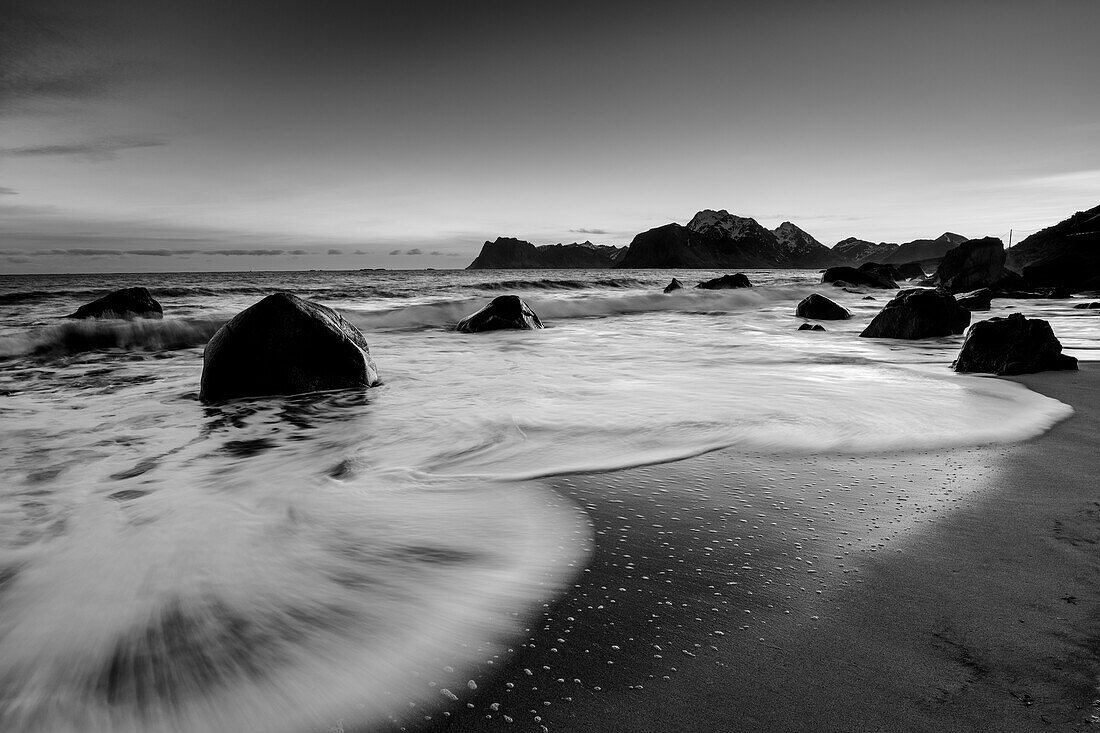 Sandy beach with boulders and incoming surf, Myrland, Lofoten, Nordland, Norway
