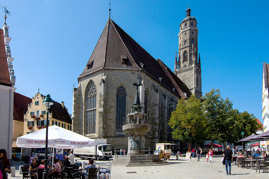 Nördlingen center, with church, Daniel tower, and market fountain, romantic street, Bavaria, Germany