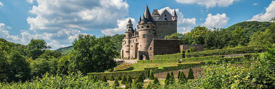  Bürresheim Castle amidst a lush garden, Eifel, Rhineland-Palatinate, Germany 