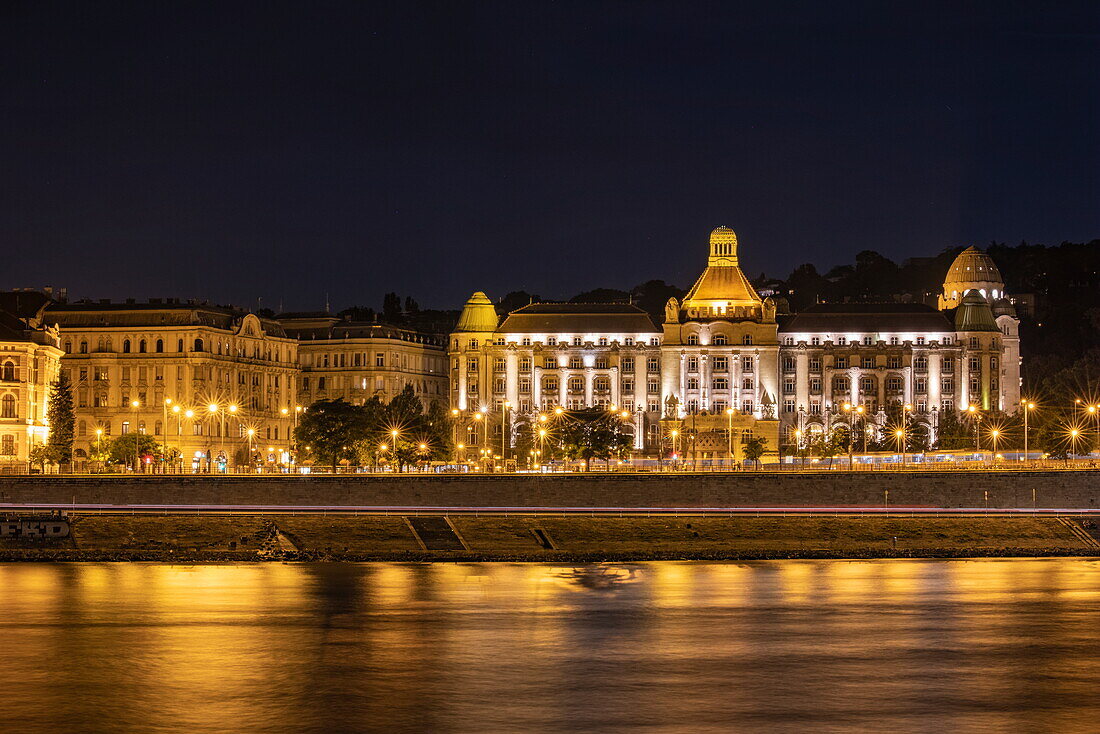 Illuminated Gellertbad building along the Danube at night, Budapest, Pest, Hungary, Europe
