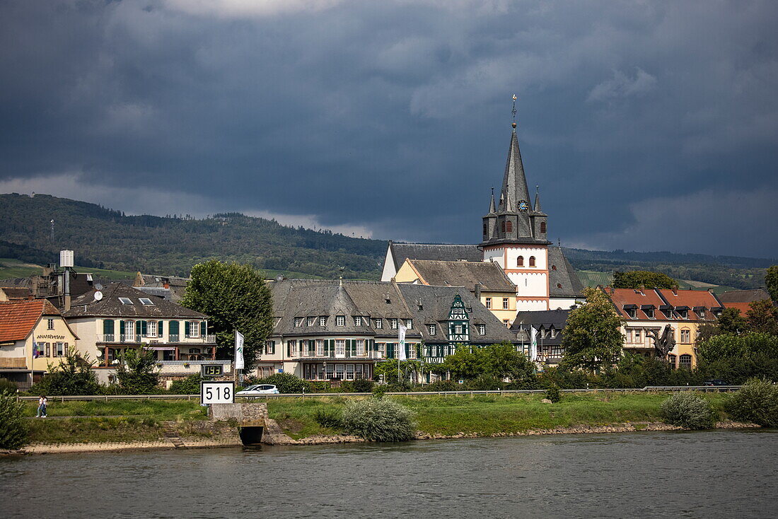 Kilometer 518 waymarker sign on the Rhine with Hotel Schwan and church seen from river cruise ship, Oestrich-Winkel, Hesse, Germany, Europe