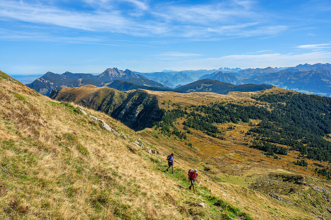 Mountaineers climbing Fürstein 2040 m with a view of Mount Pilatus 2128 m, Lucerne/Obwalden, Switzerland