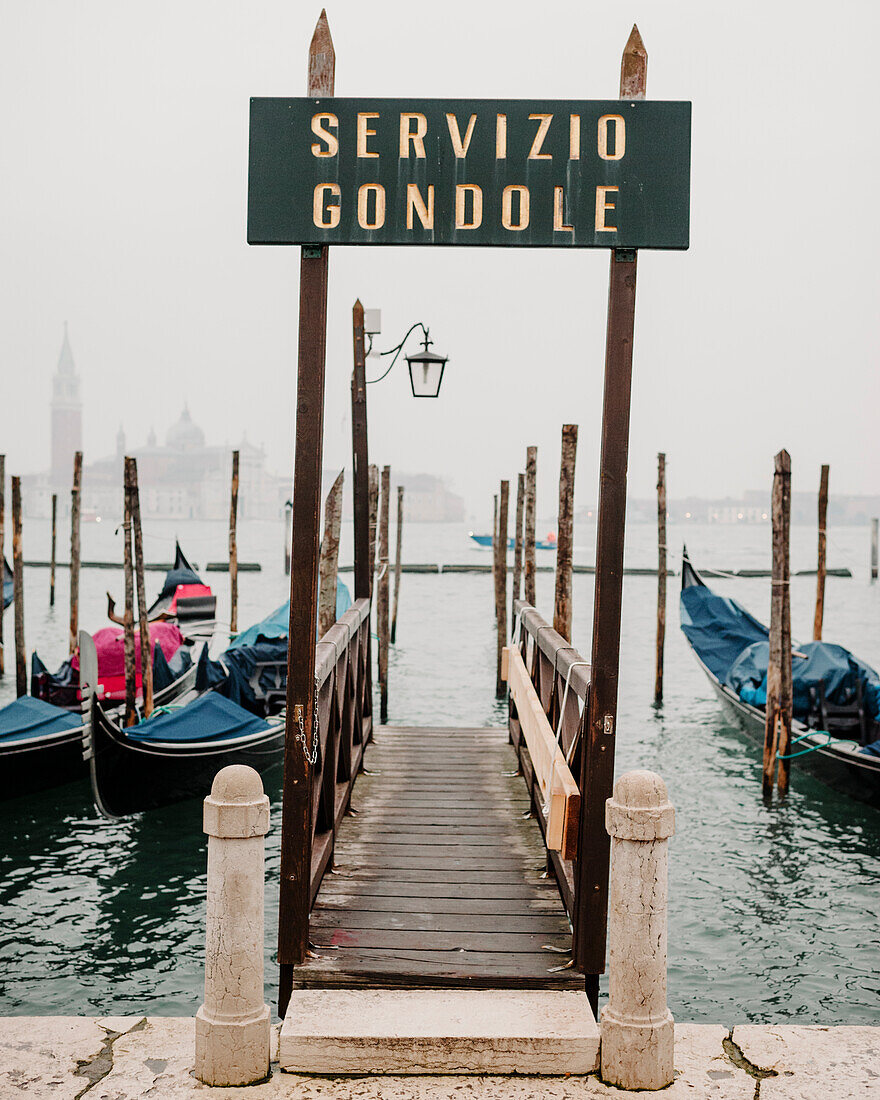 Gondolas moored on the Grand Canale in Venice with the Basilica Di Santa Maria Della Salute in the background. Venice, Italy.