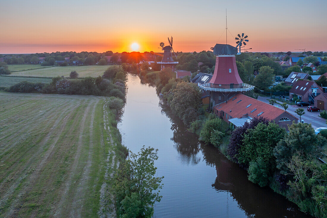  Aerial view of the twin mills of Greetsiel at sunset, Krummhörn, East Frisia, Lower Saxony, Germany 