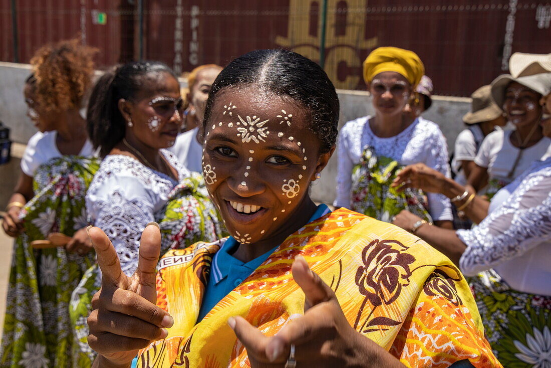  Happy local woman with Masonjoany decorative face painting during a traditional dance performance, Mahajanga, Boeny, Madagascar, Indian Ocean 