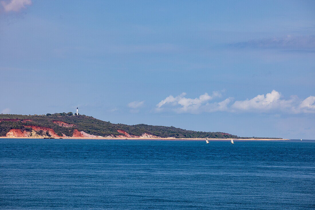  Traditional dhow sailboats and reddish colored coastline, near Mahajanga, Boeny, Madagascar, Indian Ocean 