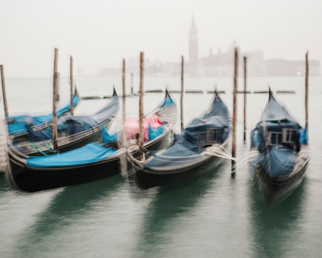 Gondolas moored on the Grand Canale in Venice with the Basilica Di Santa Maria Della Salute in the background. Venice, Italy.