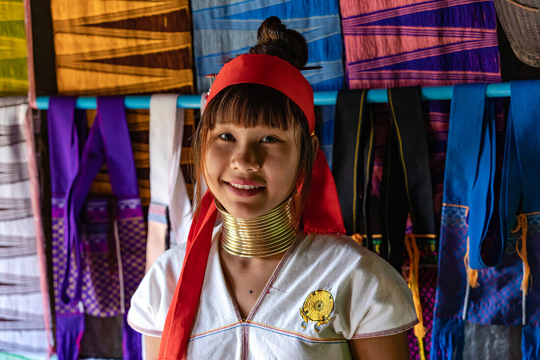  Close-up of a young Padong woman wearing traditional brass rings at Inle Lake in Myanmar, representing the cultural splendor of the Kayan tribes 