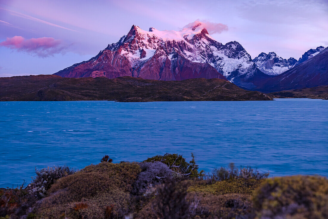  Dawn at the snow-capped Cerro Paine Grande peak behind Lake Pehoe, Torres del Paine National Park, Chile, Patagonia, South America 