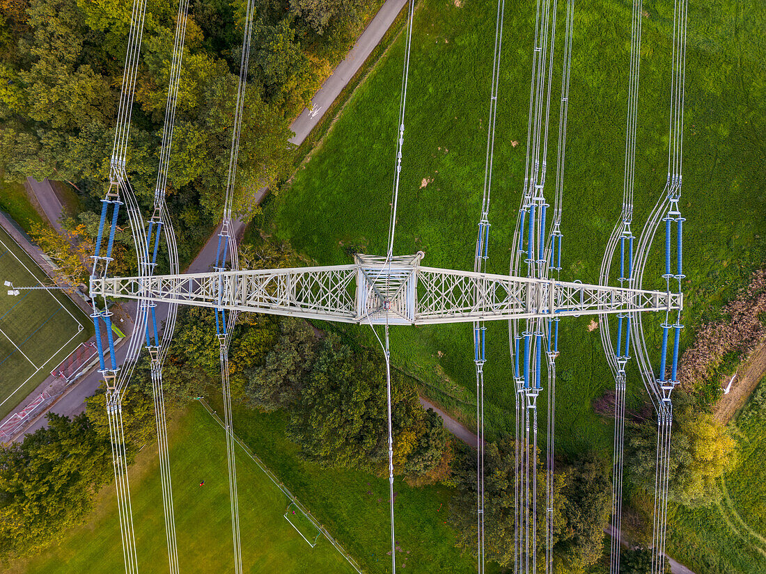  Top shot of a high voltage pylon with power lines in green nature as technology in nature 