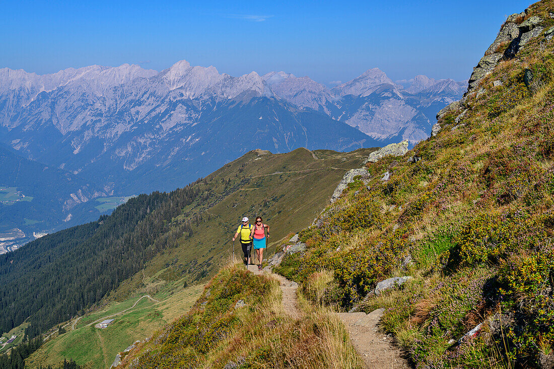  Man and woman hiking to Kellerjoch, am Kellerjoch, Tux Alps, Tyrol, Austria 
