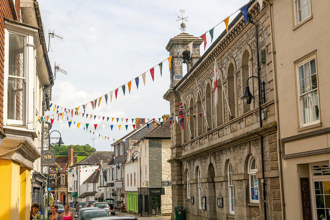 Bunting corsing street between Town hall and shops, Ashburton, south Devon, England, UK