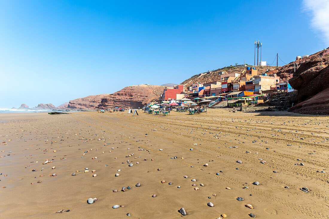 Sandy beach and buildings, Legzira, southern Morocco, north Africa