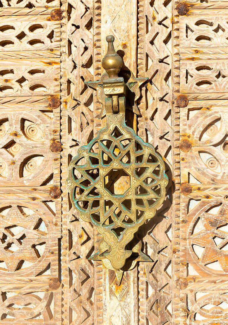 Ornate design brass knocker wooden doorway, Hotel auberge Dar Najmat, Mirleft, southern Morocco, north Africa