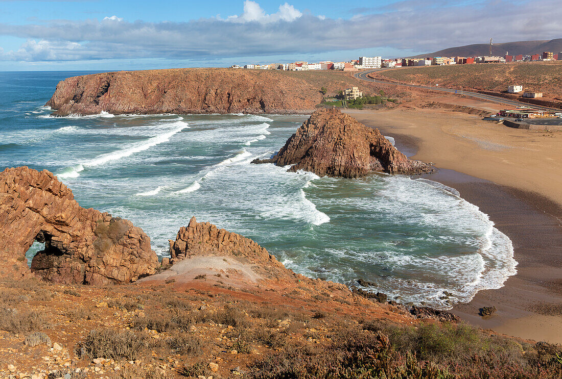 Beach rocky outrcop coastline in bay, Plage Sidi Mohammed Ben Abdellah, Mirleft, Morocco, north Africa