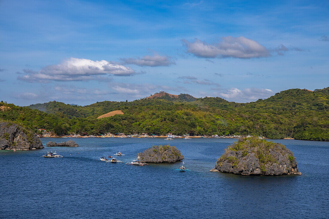  Bangka outrigger canoe tour boats take snorkelers to Siete Pecados, a cluster of seven small islands near Coron, Palawan, Philippines 