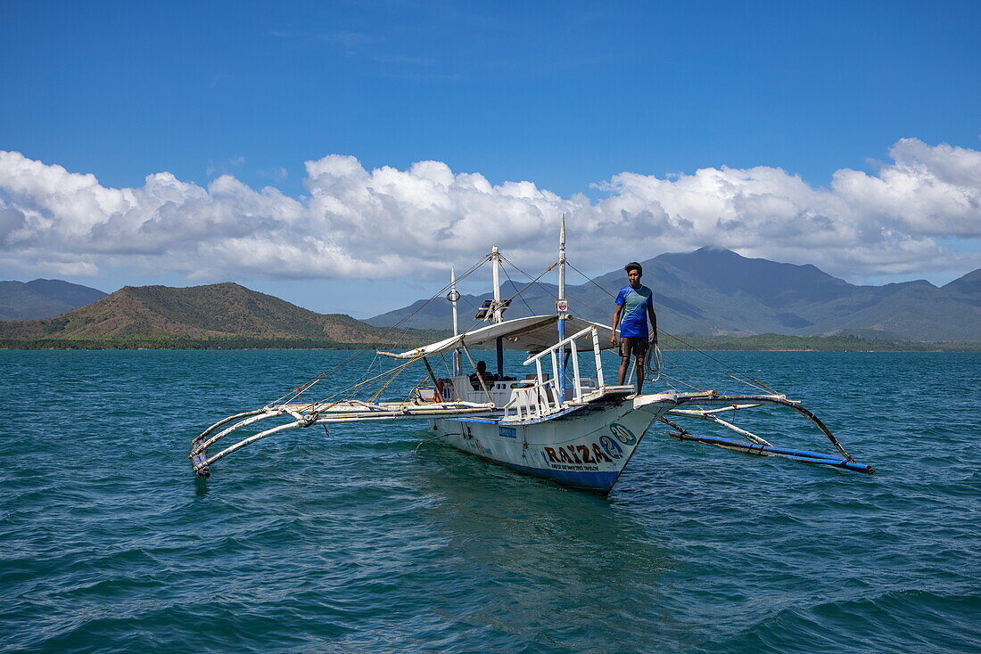  Bangka outrigger canoe tour boat with coast in the distance, Honda Bay, near Puerto Princesa, Palawan, Philippines 