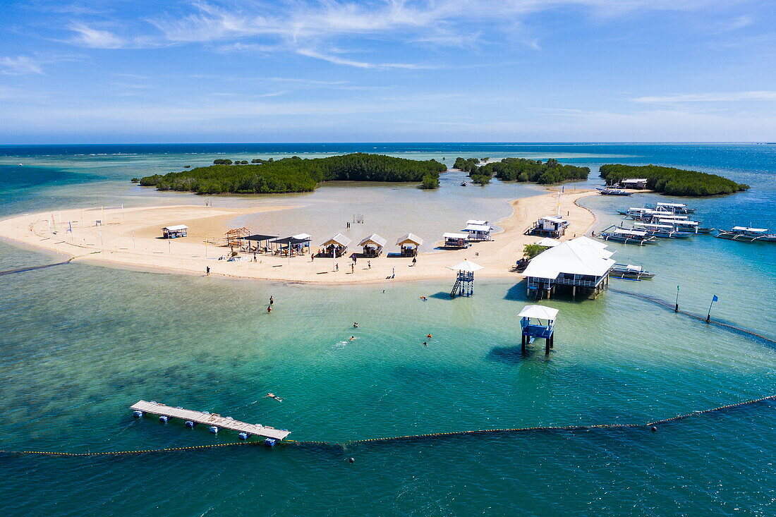  Aerial view of people relaxing on the beach and Bangka outrigger canoe tour boats on Luli Island, Honda Bay, near Puerto Princesa, Palawan, Philippines 