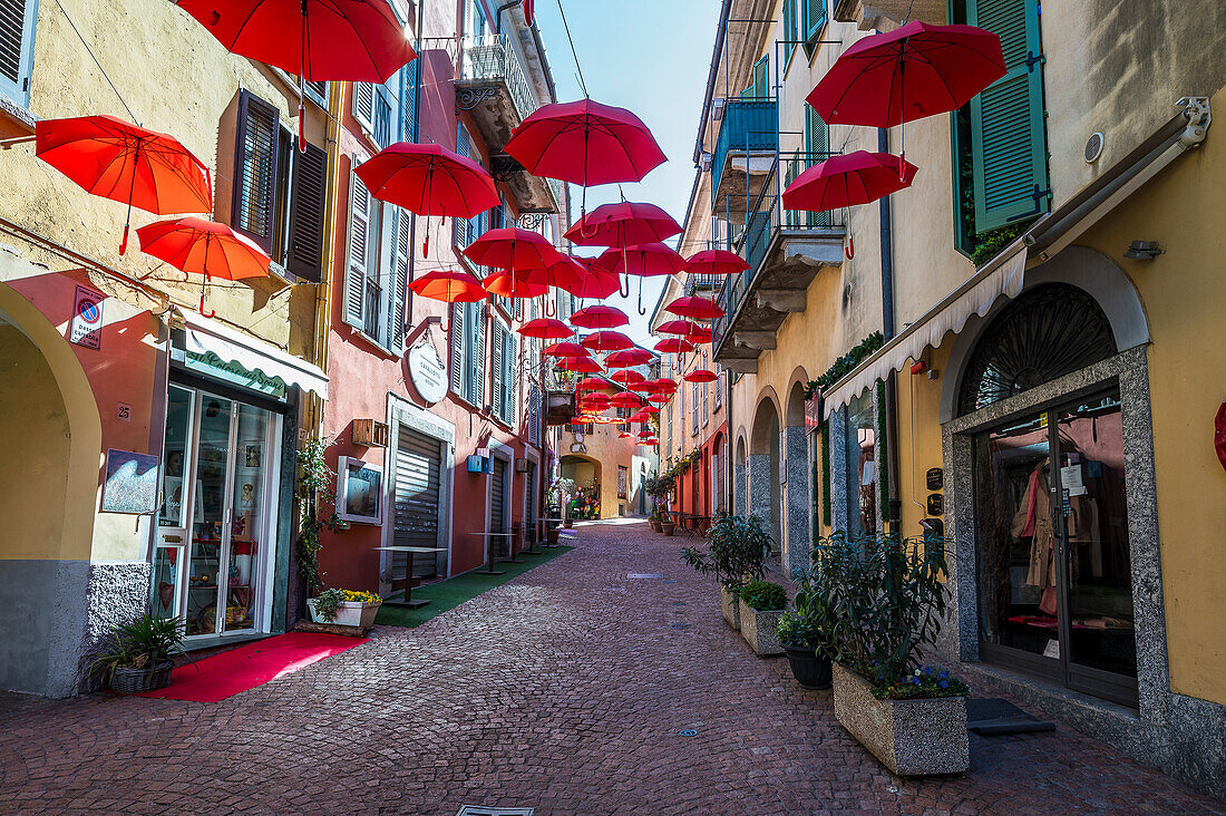  Red umbrellas in the old town of Luino, Varese province, Lake Maggiore, Lombardy, Italy, Europe 